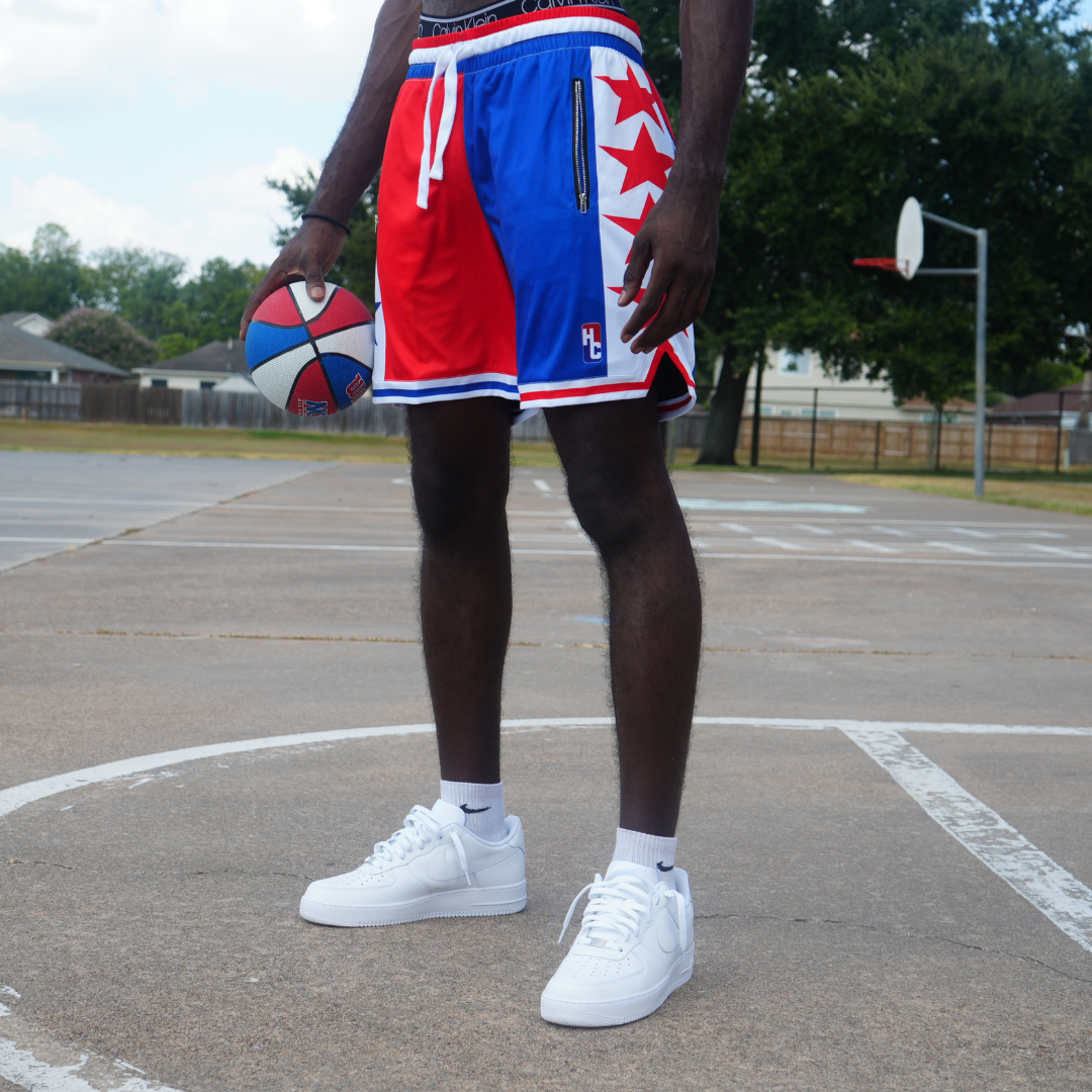 Fire & Ice Shorts reversible 2 in 1 design with polyester mesh, zipper pockets, and wide drawstrings on basketball court.