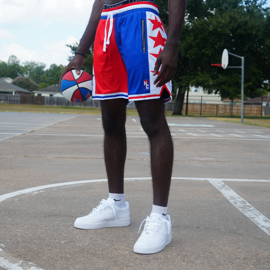 Fire & Ice Shorts reversible 2 in 1 design with polyester mesh, zipper pockets, and wide drawstrings on basketball court.